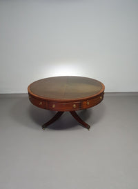 Mahogany Victorian " Heldense " Coffee table / Drum table with leather top on brass wheels. '80s