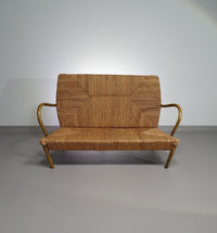 Vintage French papercord sofa with a metal frame base