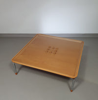 Rare coffee table 110 x 110 x height 35 cm
with 8 flange wooden / cork caps in the glass top.