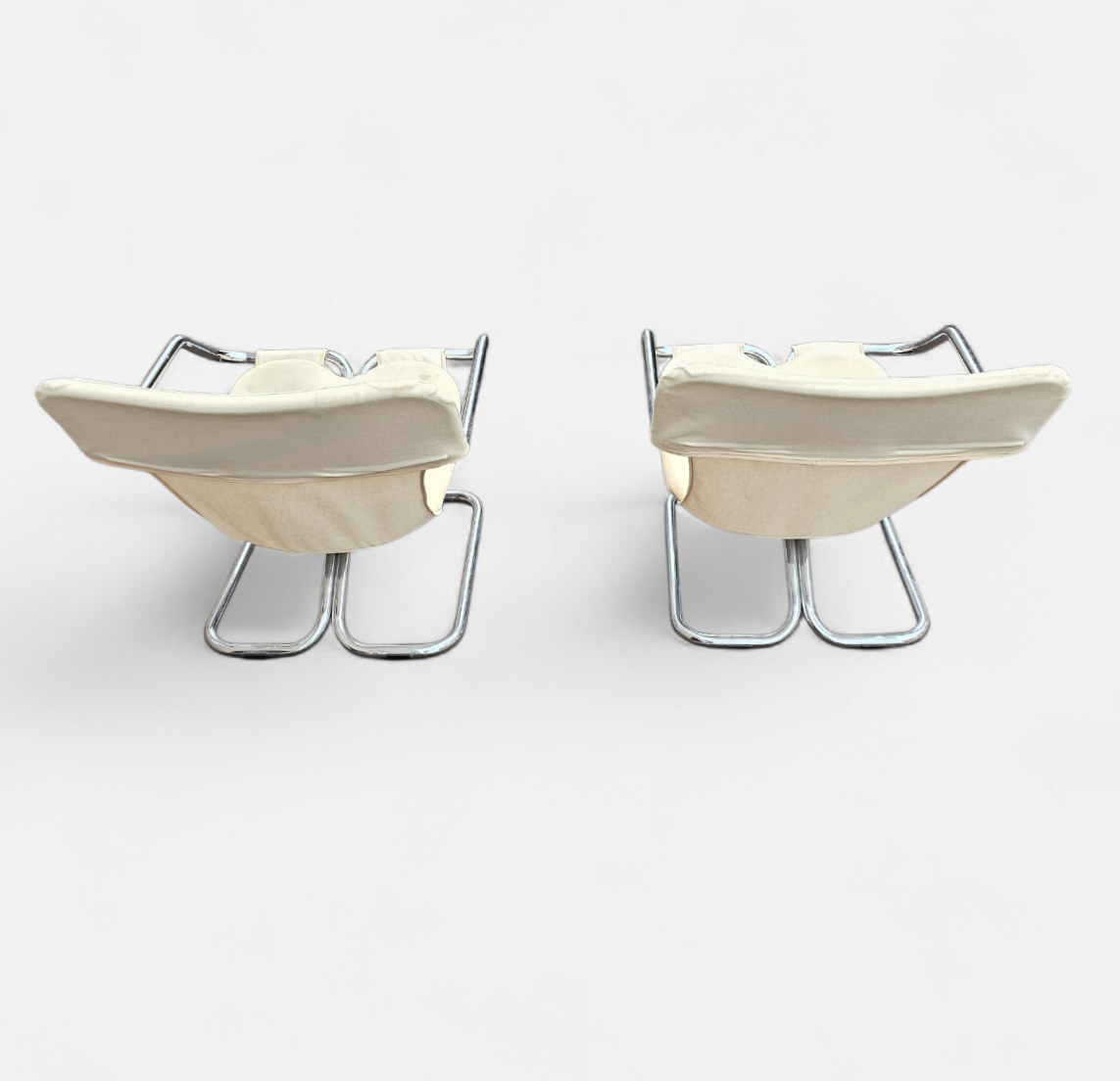 2 x Tubular chrome cantilever chair with a cream canvas sling