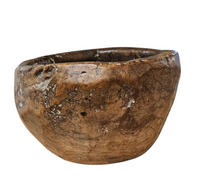 A substantial hand-hewn wooden bowl carved from a single burl section
