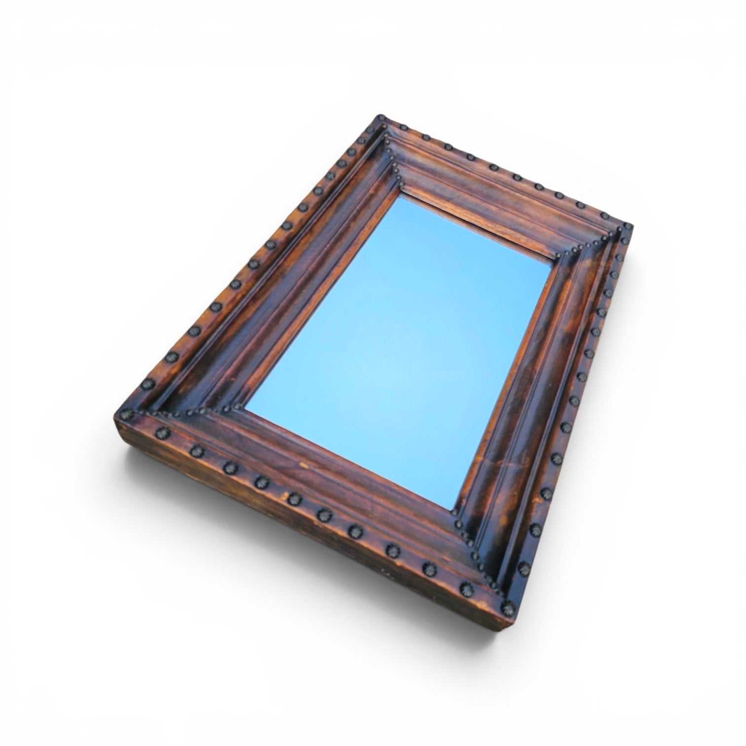 Vintage mirror features a cool combination of a leather covered frame and studs