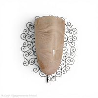 Wrought iron pocket wall sconces featuring a frosted amber glass / metal frame