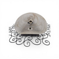 Wrought iron pocket wall sconces featuring a frosted amber glass / metal frame
