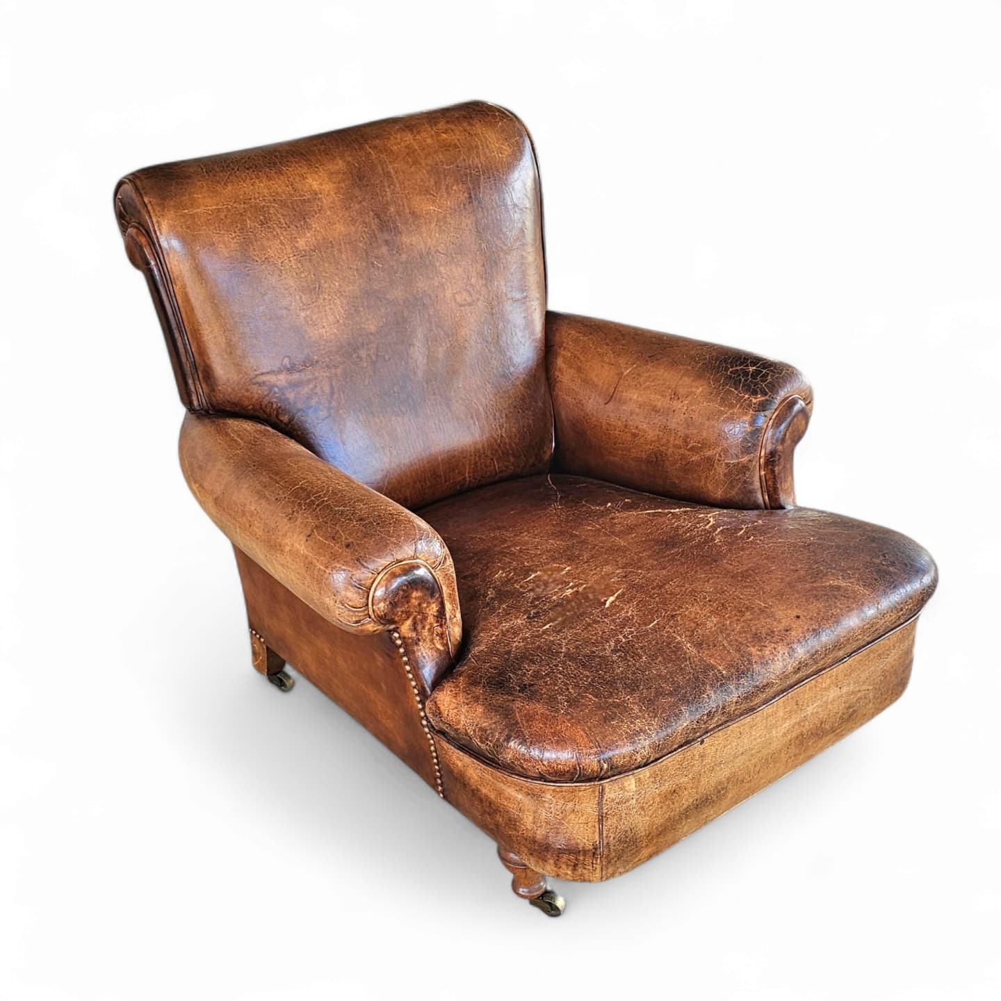 Beautiful and stately old English sheep leather club chair with armrests