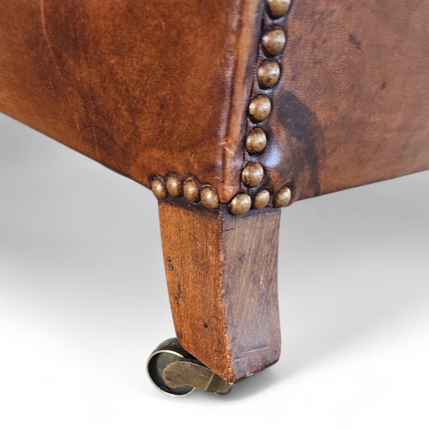Beautiful and stately old English sheep leather club chair with armrests