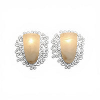 Wrought iron pocket wall sconces featuring a frosted amber glass / metal frame