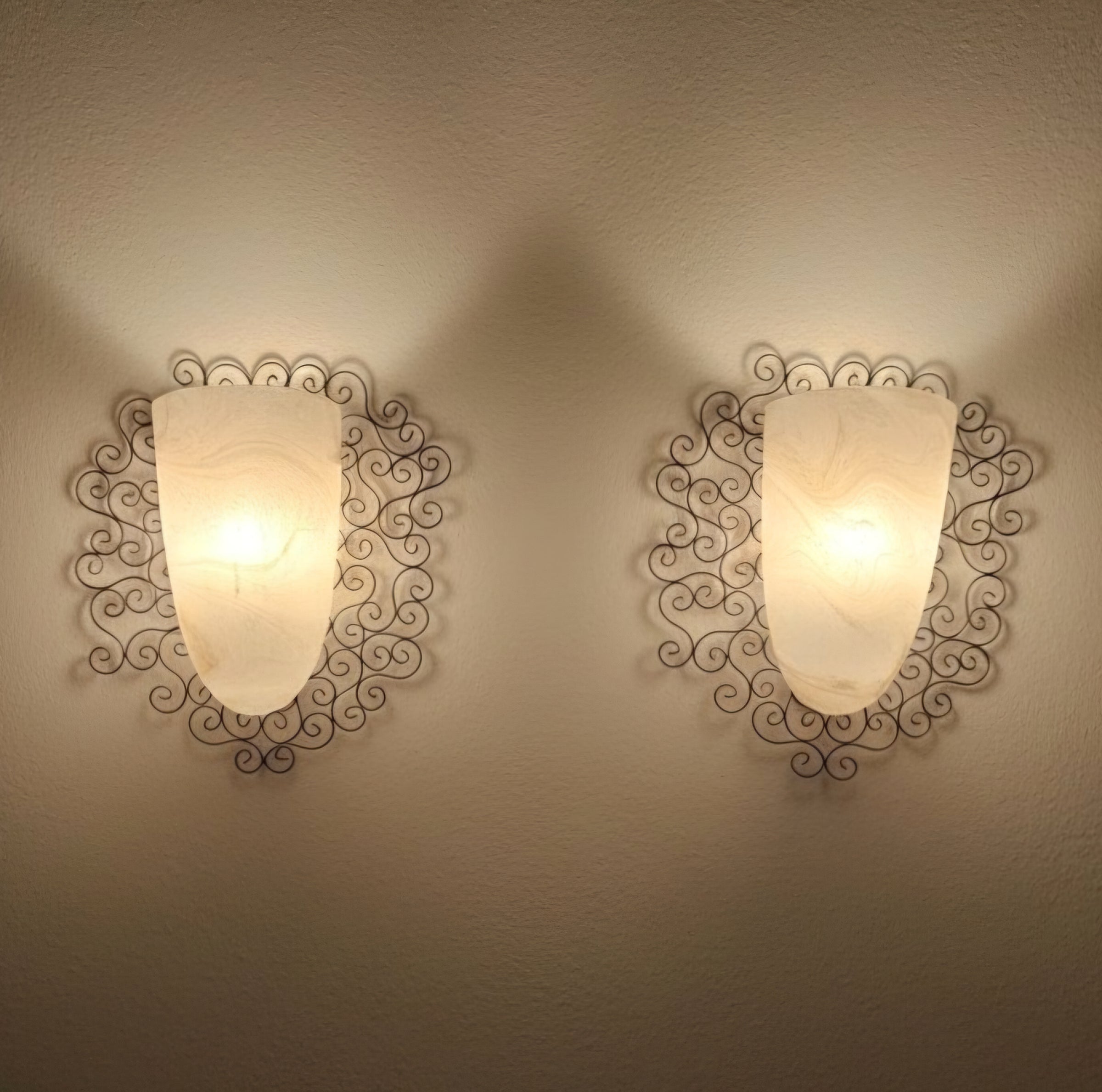 Wrought iron pocket wall sconces featuring a frosted amber glass / metal frame