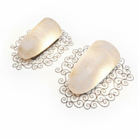 Wrought iron pocket wall sconces featuring a frosted amber glass / metal frame