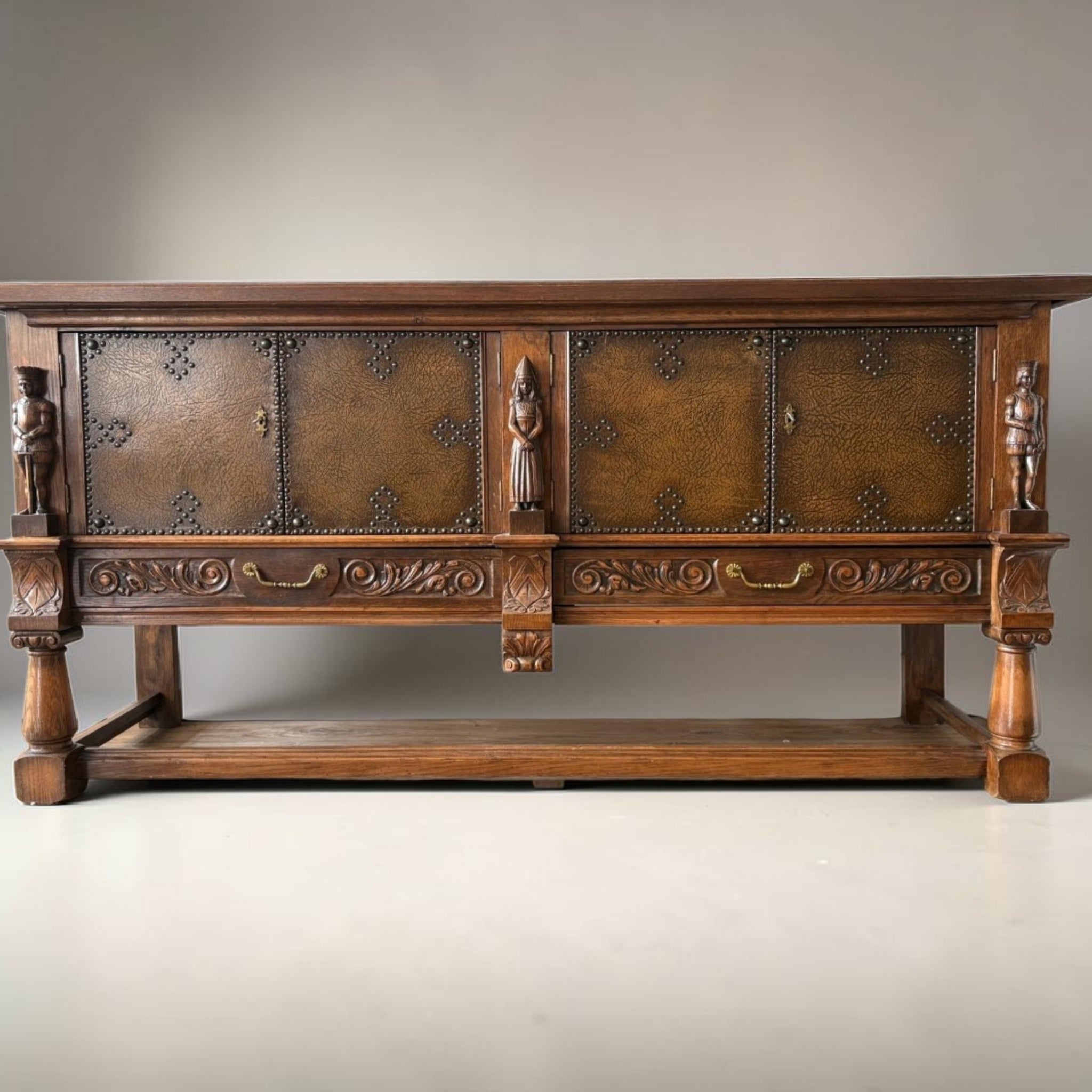 Mechelen Spanish sculptured sideboard / leather covered panels with decorated nails / 1960s