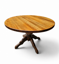 solid oak dining table / also known as a monastery table / with a sturdy central pedestal / Its heavy-duty construction