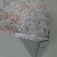 A free form large granite coffee table with three straight lines contrasting to a wavy front. 1970s