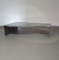 A free form large granite coffee table with three straight lines contrasting to a wavy front. 1970s
