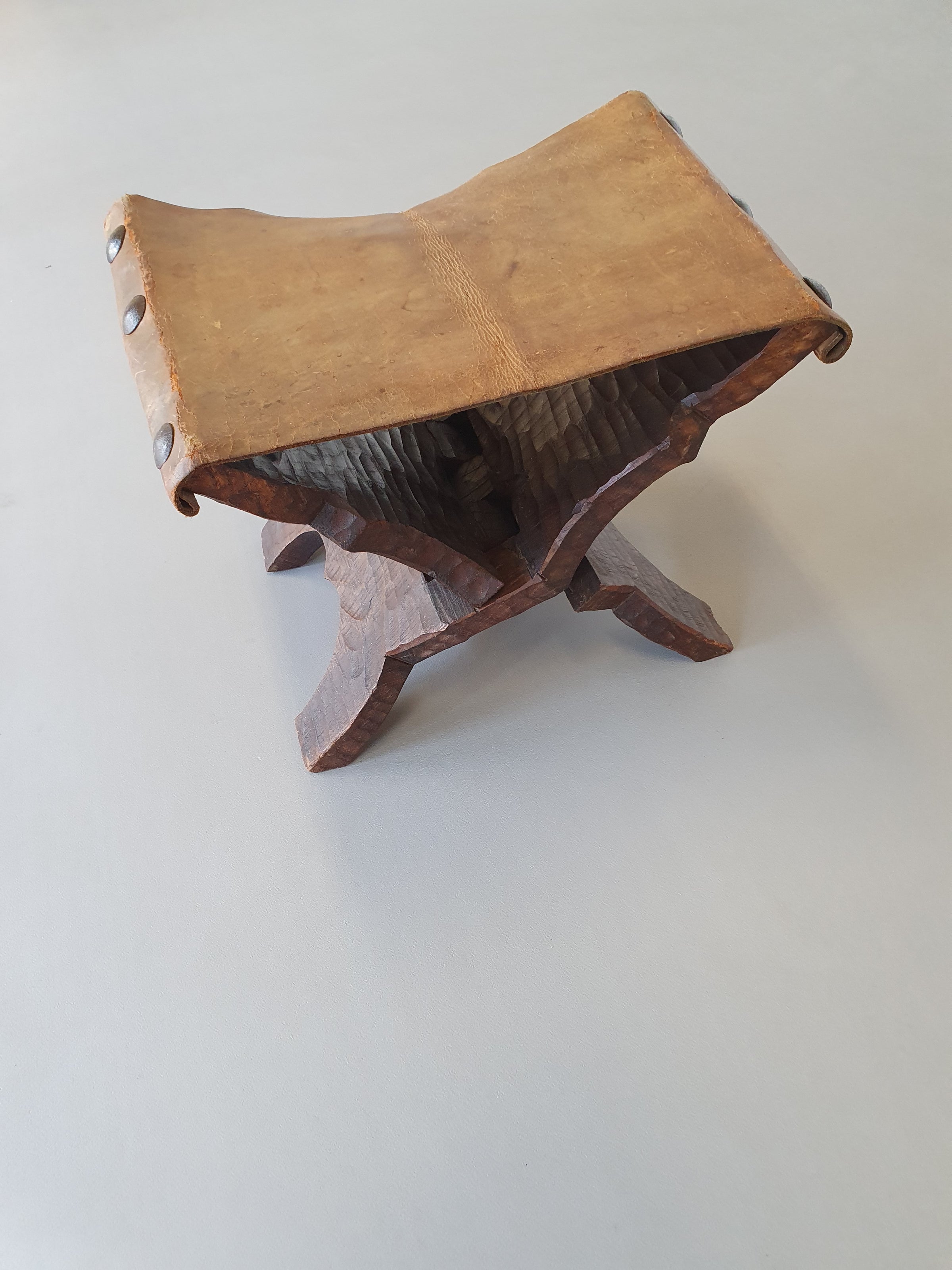 Small brutalist folding stool with leather seat 1950s