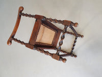 Wokkel chair with armrests and webbing seat.